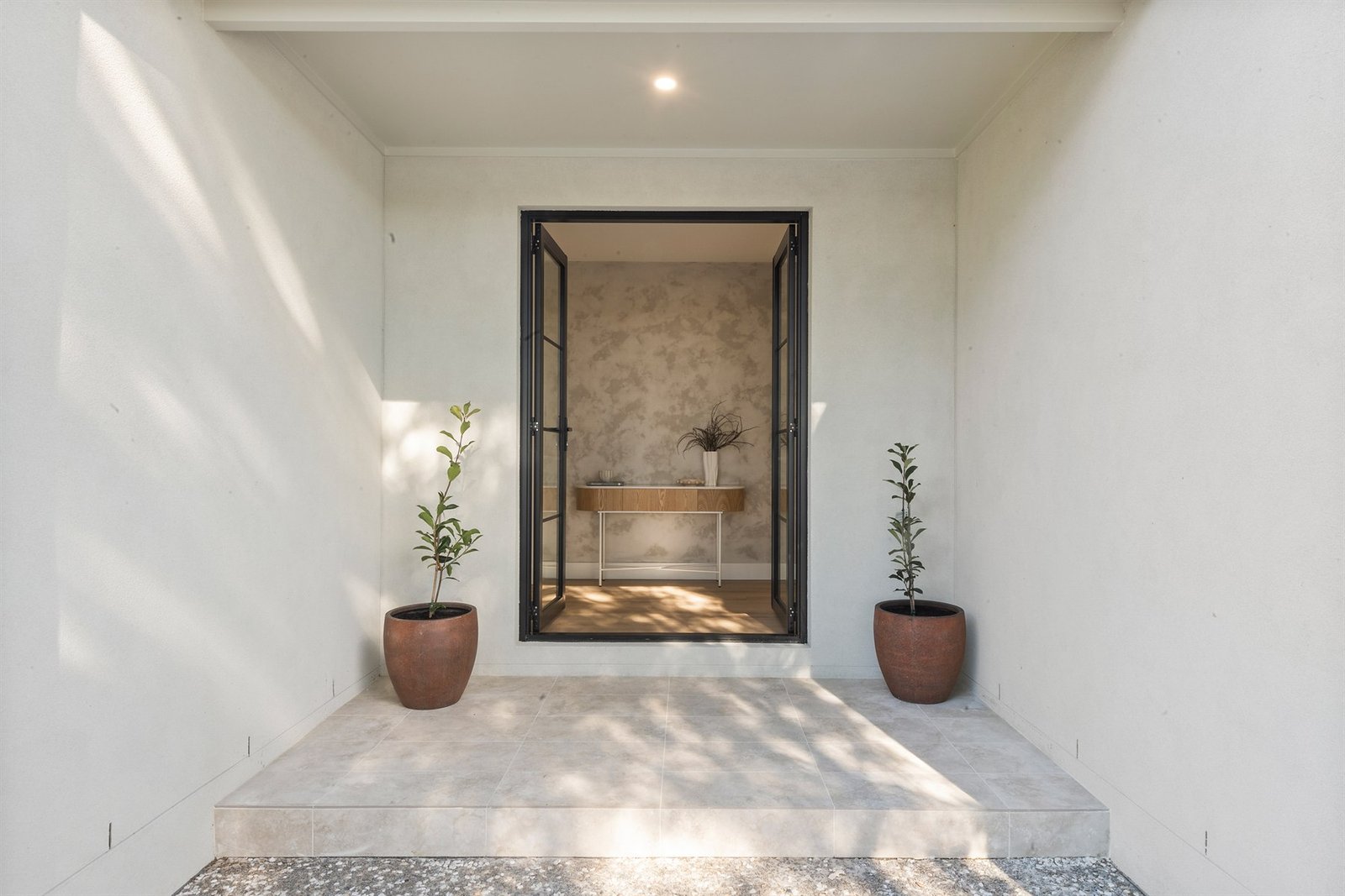 Covered entry with view through to finished bathroom